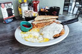 Biscuits Cafe signature dishes Chicken Fried SteakBreakfast BurritoHuevos RancherosChicken and Waffle